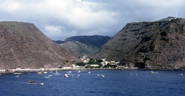 This photo of the harbor at Jamestown, the capital of the island nation (founded in 1659) of St. Helena, was taken by Andrew Neaum and is used courtesy of the Creative Commons Attribution ShareAlike 3.0 License. (http://commons.wikimedia.org/wiki/File:St-Helena-Jamestown.jpg)